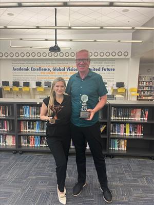 Partners holding trophies